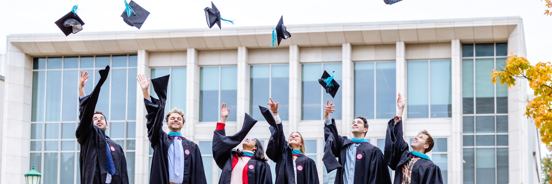 Happy grads throw caps