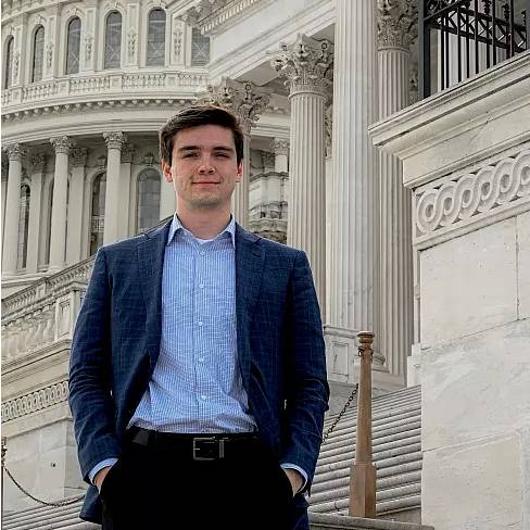 headshot in front of dc buildings