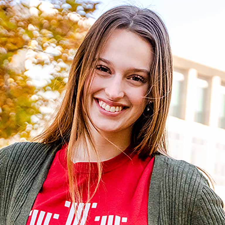 Smiling woman in IU shirt with O'Neill School in the background.